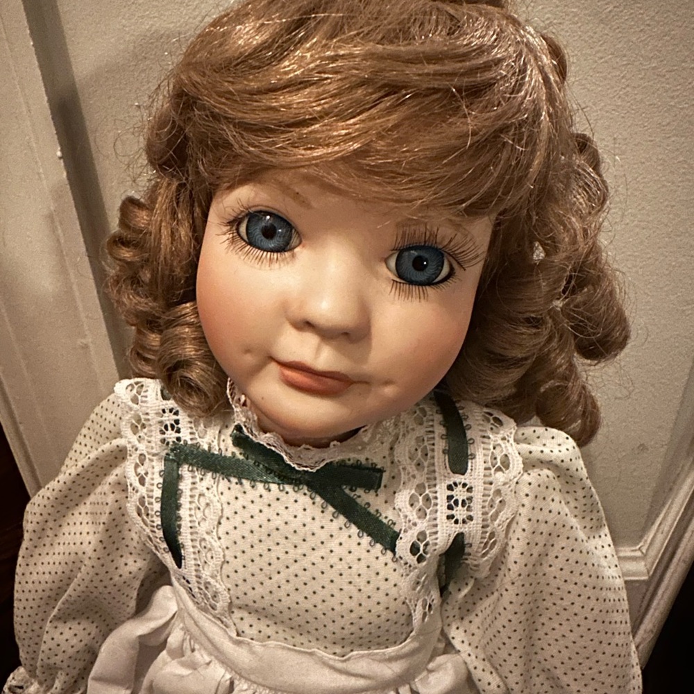 Vintage Porcelain Doll with Blue Eyes and Lace Dress